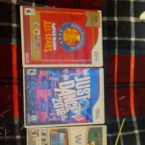 Wii with 5 games and 2 controls plus the controller wheel accessory